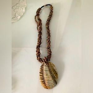 Beaded necklace with hanging shell